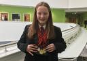 Ysgol Treffynnon student, Ellen Davies, with her haul of swimming medals.
