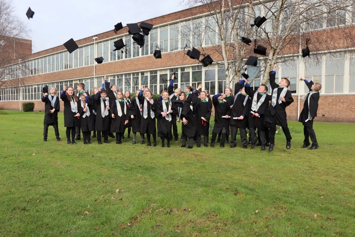 Childrens University Graduates celebrate outside Wrexham University. 
