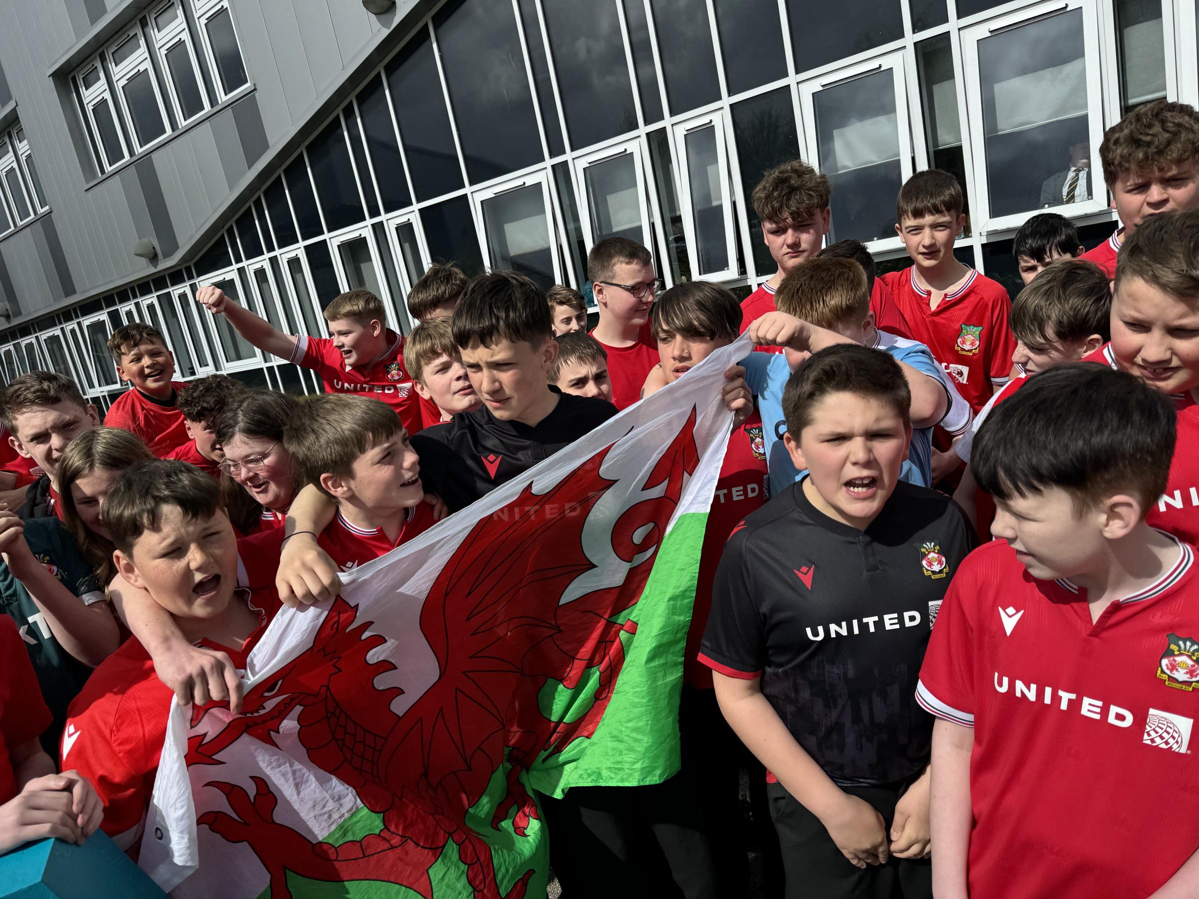 Seeing red - Ysgol Bryn Alyn celebrate Wrexham AFCs league promotion.