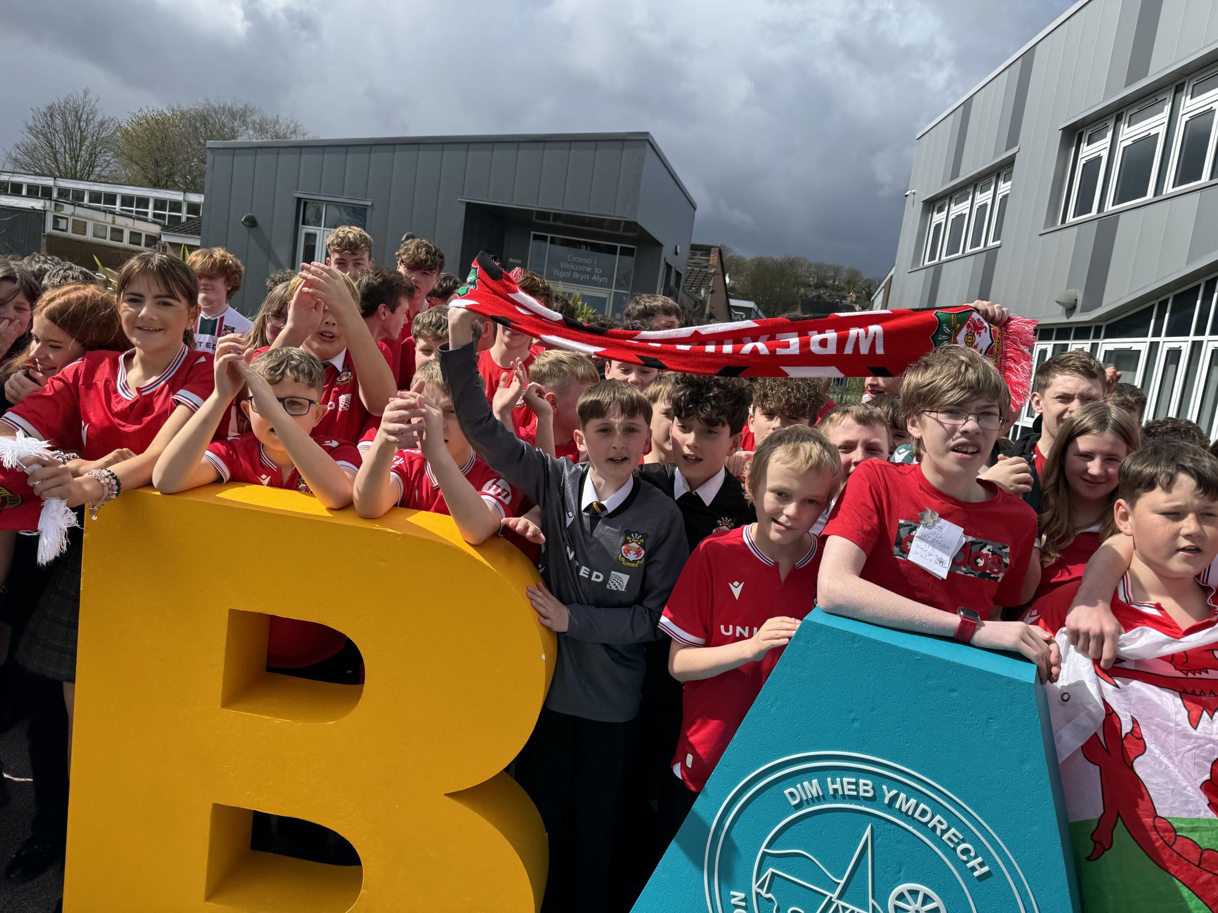 Seeing red - Ysgol Bryn Alyn celebrate Wrexham AFCs league promotion.
