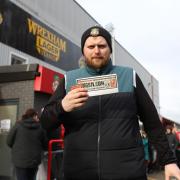 Wrexham AFC supporter, Craig Herling, 28, from Cefn-y-Bedd shows off his Kings of Leon tickets after pre-sales opened for May’s two shows Wednesday morning