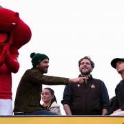 Wrexham co-owner Ryan Reynolds, executive director Humphrey Ker and co-owner Rob McElhenney celebrate on an open-top bus during a victory parade in Wrexham, Wales. during a victory parade in Wrexham, Wales. Picture date: Tuesday May 2, 2023. PA Photo.