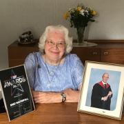 Enid with her 2020 Teenage Cancer Trust Award, and a photo of her late grandson Richard