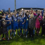 DENBIGH, WALES - 06 APRIL 2024: Mold Alex lift the trophy following their 3-1 victory in the 2024 Welsh Blood Service League Cup North Final between Llandudno and Mold Alexandra at Denbigh's Central Park Stadium on the 6th of April 2024. (Pic by Nik