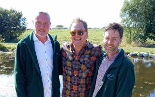 Brook Cottage Shepherd Hutt owners Mark Barrow and Jonathan Gooders with Alan Carr.