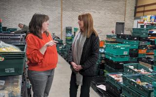 Lesley Griffiths MS with Wrexham Foodbank manager Amy Jones during her visit to the site.