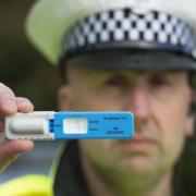 A police officer with a drugs test