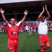Wrexham manager Brian Flynn (left) and coach Kevin Reeves walk out for their match against Manchester United in a pre-season friendly game at The Racecourse Ground, Wrexham, Wales.
