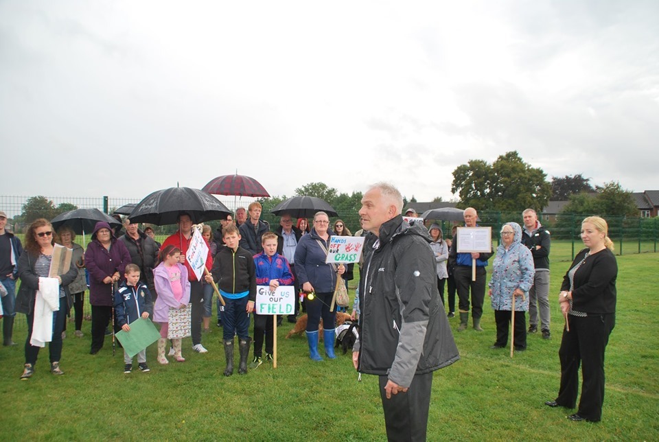 Almost 100 people gathered at Dean Road field in Rhosnesni in September 2019 following Glyndwr Universitys move to put a fence across it. Source: Marc Jones