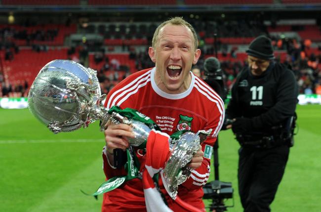 Wrexham's player manager Andy Morrell celebrates with the trophy after his side win the FA Carlsberg Trophy Final at Wembley Stadium, London. PRESS ASSOCIATION Photo. Picture date: Sunday March 24, 2013. See PA story SOCCER Trophy. Photo credit