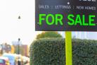 For Sale sign displayed on a street in the UK.