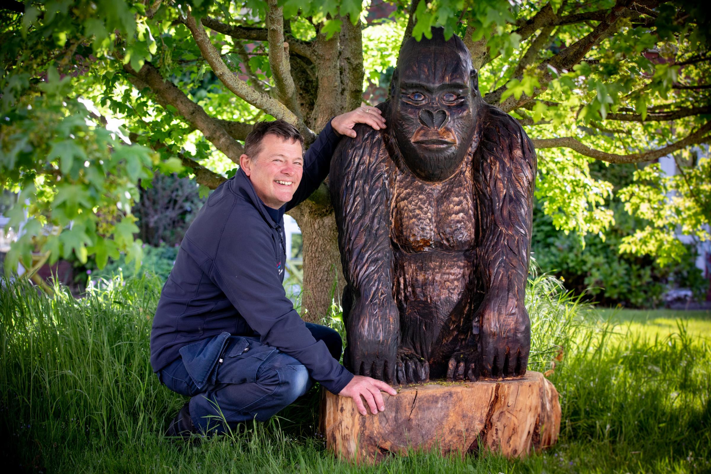 Pendine Parks Paul Morris, from the maintenance team, with one of his tree sculptures, which sits amongst the trees on the site. Photo: Mandy Jones