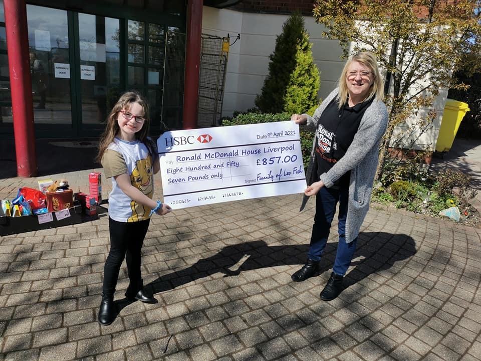 Evie with the cheque donated to Ronald McDonald House.