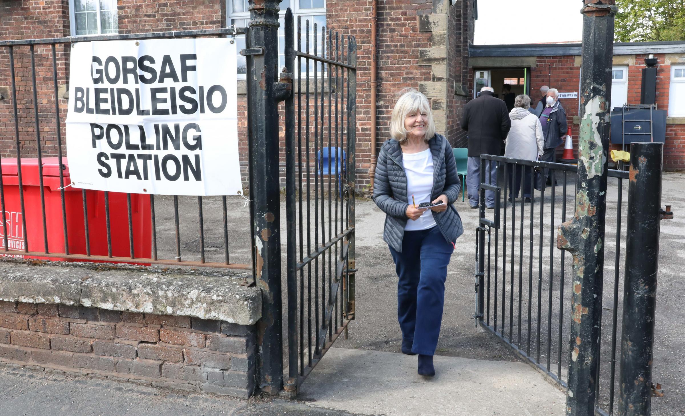 Penyfford Youth and Community Centre Queue to vote - Jane Lloyd leaves after casting her vote