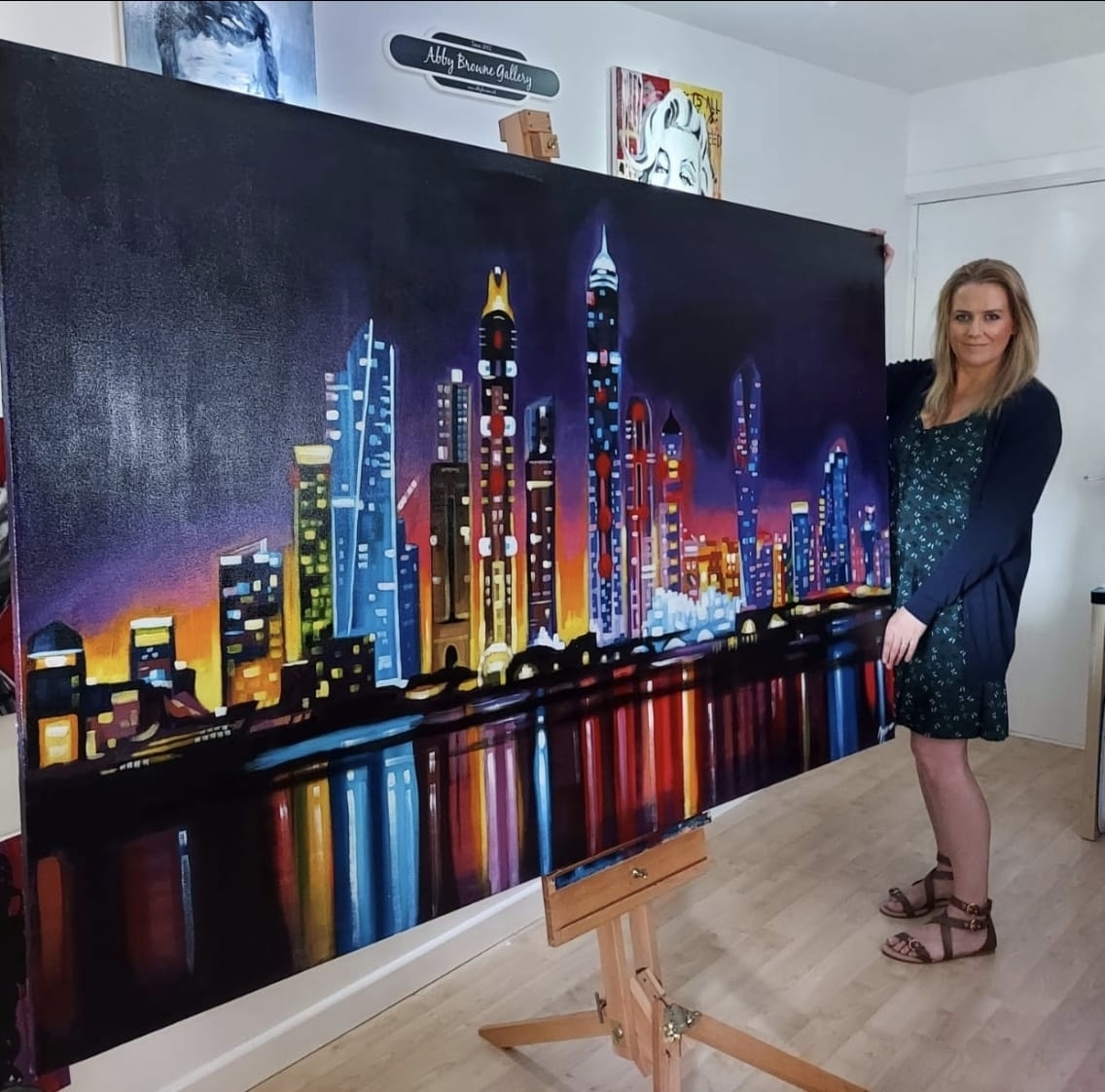 Abby with her Dubai skyline painting.