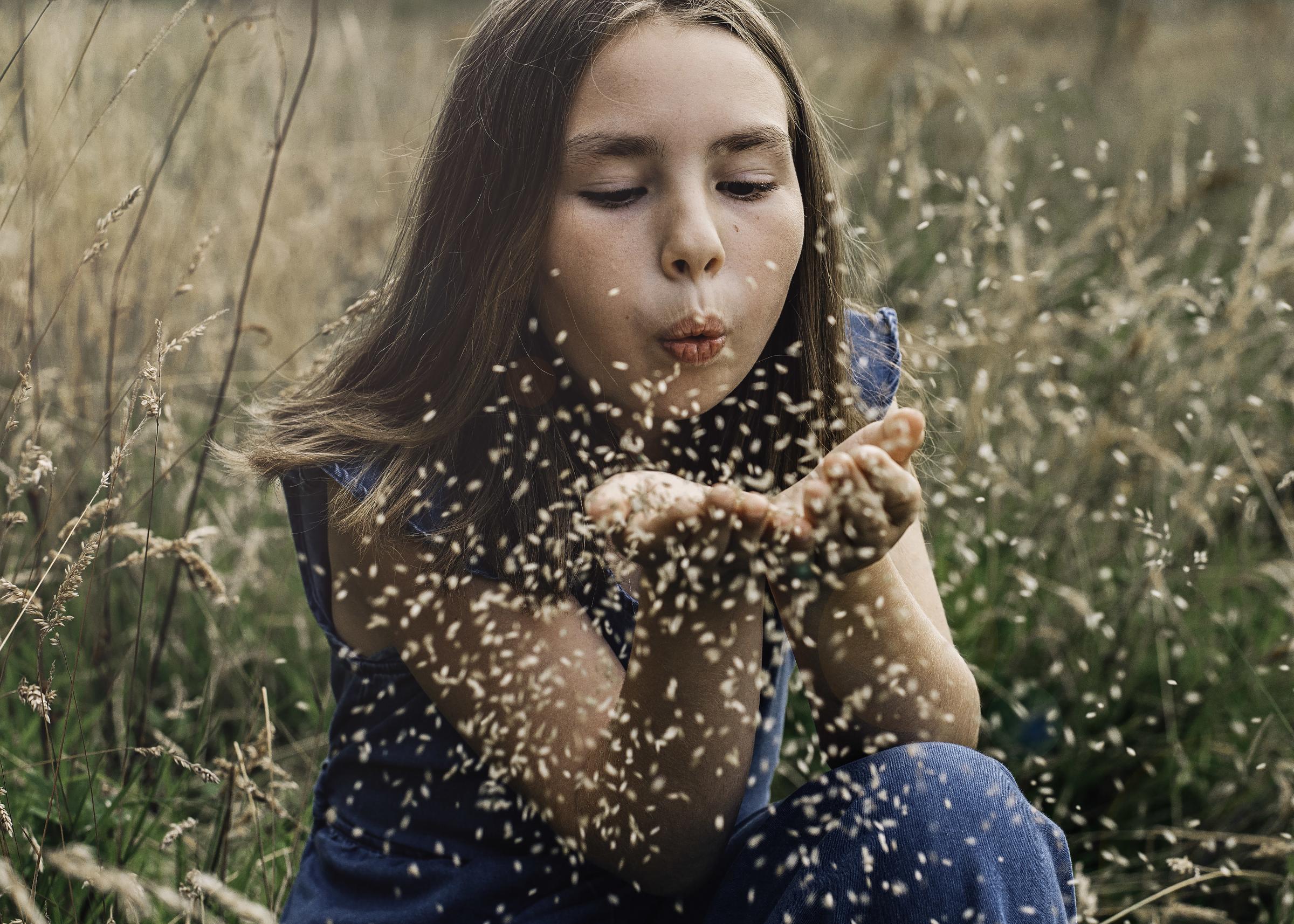 Girl blowing seeds (c) Evie and Tom Photography / 2020 Vision. 