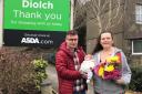 Delyth Jones and Dean Stawman - pictured with baby Harry who made his dramatic entrance into the world in the car park of Asda’s Pwllheli store. [Image: ASDA]