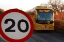 A 20mph sign and school bus
