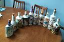 Some of Elaine Hughes' decoupage bottles, made and sold for charity.