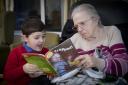 Harri Shone, who visits Pendine Park after school to read stories residents, is pictured with Betty Newcombe. Photo: Mandy Jones