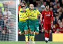 Norwich City's Teemu Pukki (right) celebrates scoring his side's first goal of the game during the Premier League match at Anfield, Liverpool..