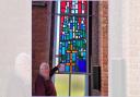 Mike Bunting with one of the newly installed stained glass window.
