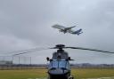 The H175M with the Airbus BelugaXL taking off in the background at Hawarden airport.