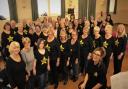Mold Rock Choir with their conductor, Rebecca Broadbere