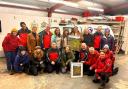 The Walkabout Women present a print of The Gully to members of the Aberglaslyn Mountain Rescue Team.