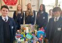 Year 9 students Isla Bowhill, Evie Brown and Lexi Jones, and Finn Bebbington and Morgan Roberts, year 7, with some of the donated items.