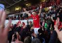 Wrexham's Paul Mullin celebrates with fans after winning promotion last season.