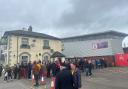 Crowds gather outside The Turf and The Racecourse ahead of today's game.