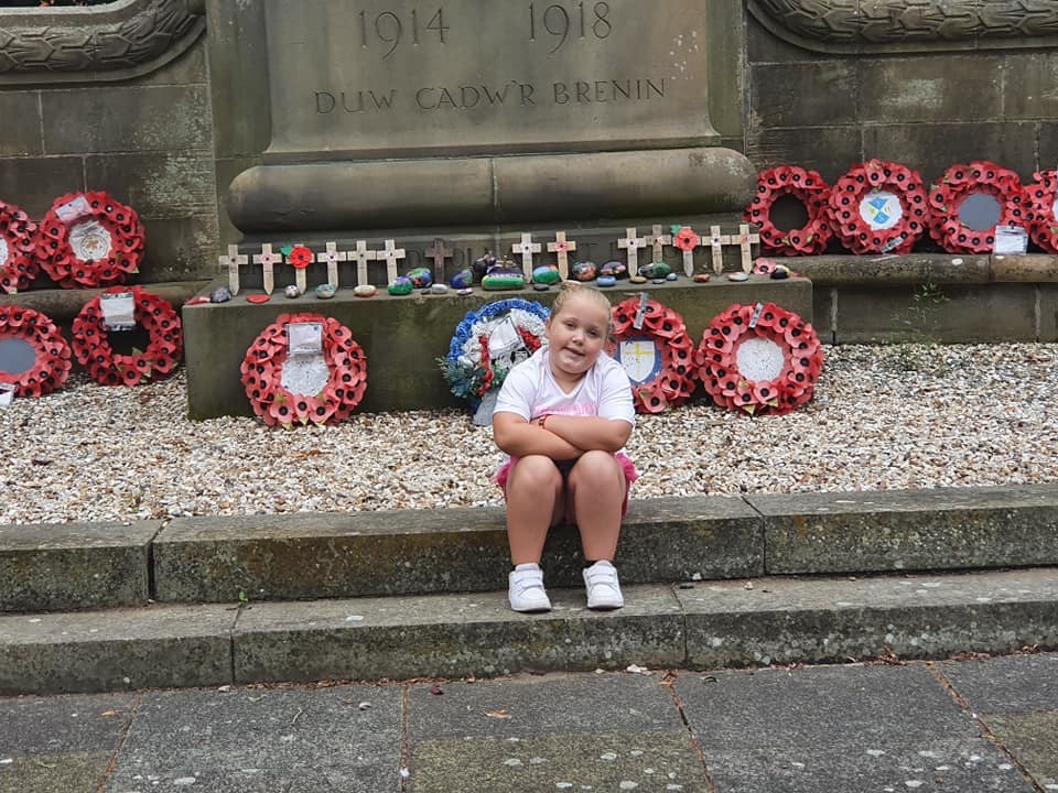 Lily Haggarty at the Cenotaph in Wrexham after she and mum Louise tidied it up.