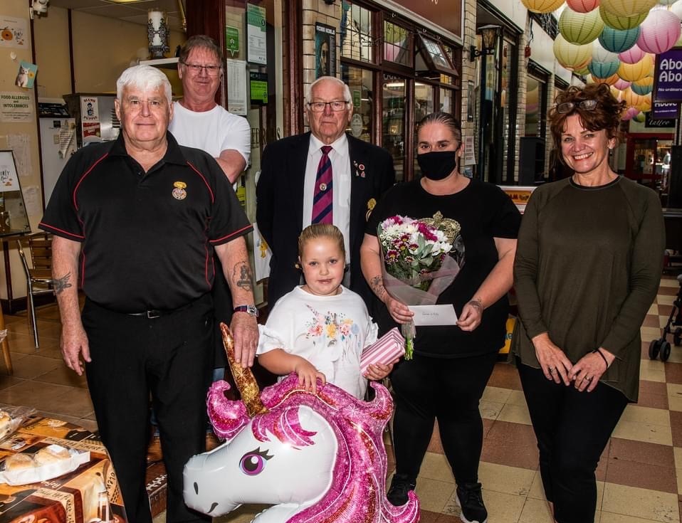 Pictured with Lily Haggarty are Stephen Beale secretary of the Welch Fusiliers Comrades Association, shop owner Steven Vale, Association chair Tony Owens, and Sara Atherton MP.