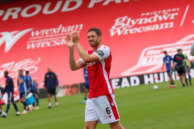 Ben Tozer applauds supporters after Wrexham's 1-0 win against Woking. Picture by GEMMA THOMAS