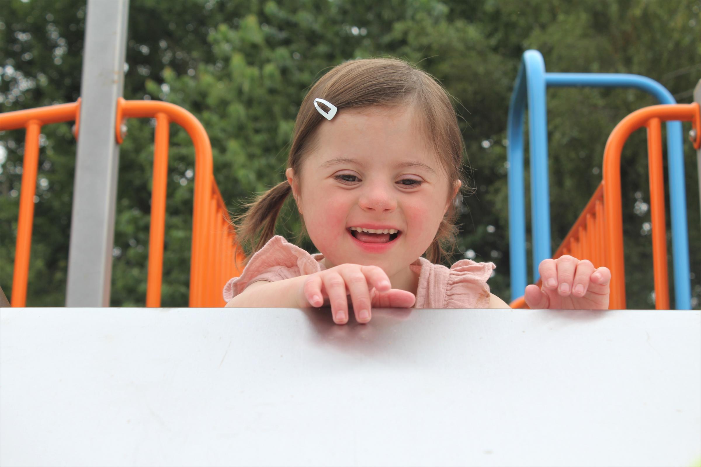 Amelia Thompson plays on the playground at Hope House.