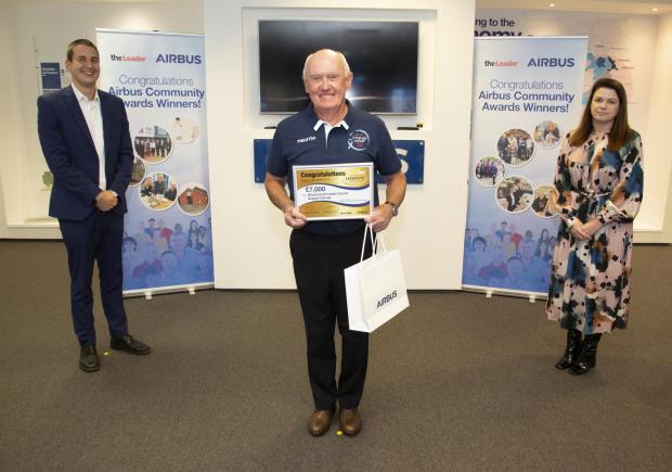 The Leader: Paul Kilmister, Airbus' Head of supply chain and The Leader editor, Susan Perry pictured with Malcolm Williams, Wrexham Prostate Cancer Support Group, awarded £7,000.