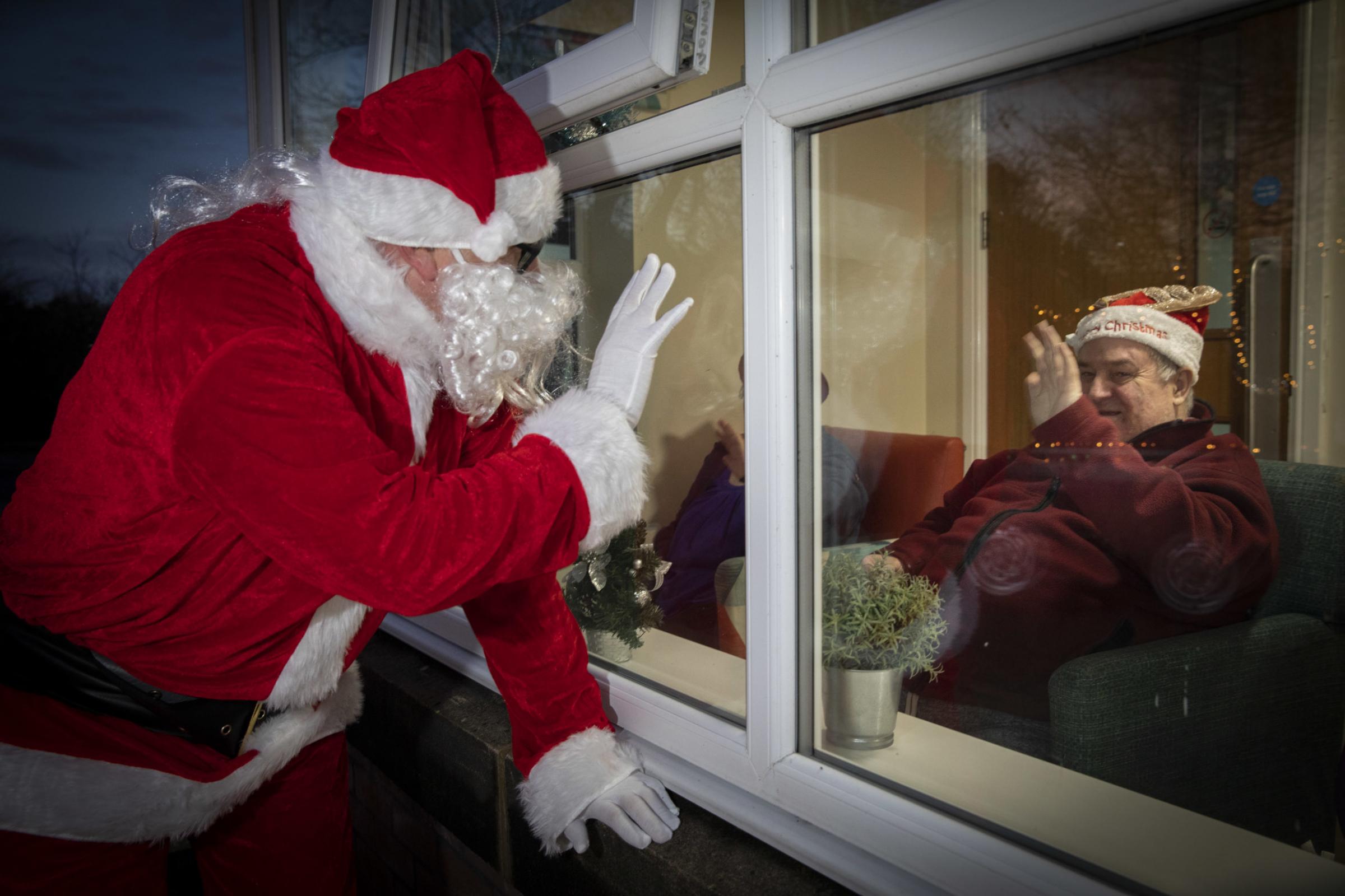 Santa at Pendine Park Summerhill to turn on the Christmas lights. Resident Georg (CORRECT) Ullman. Picture Mandy Jones
