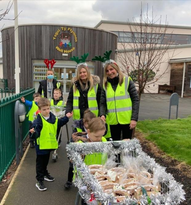 The Leader: Ysgol Ty Ffynnon staff and children making a festive delivery to school neighbours.