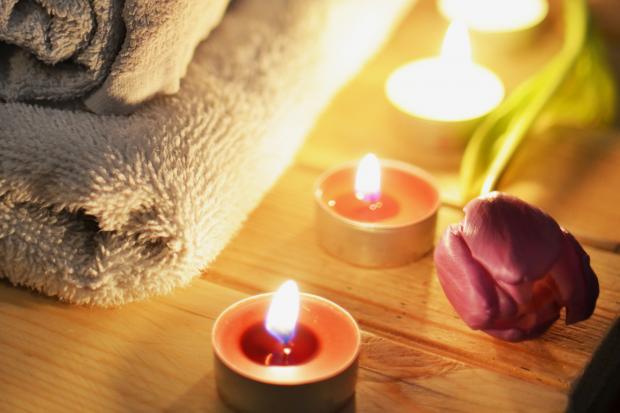 The Leader: A pile of towels, candles and a tulip. Credit: Canva