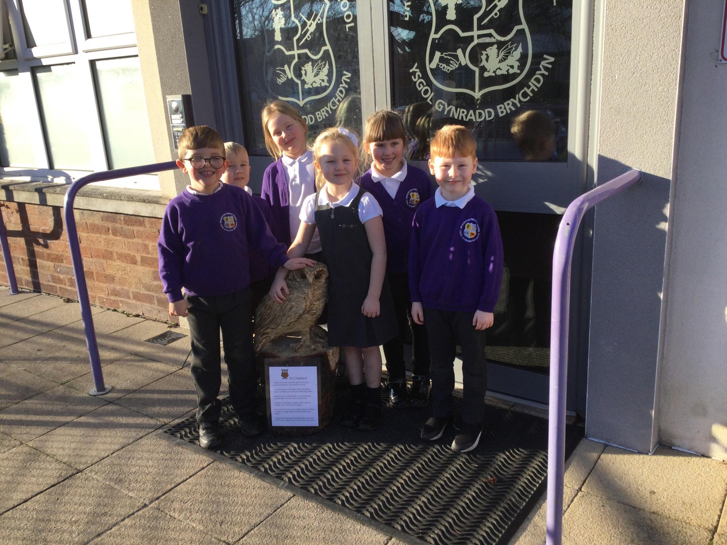 Pupils at Broughton Primary School with their owl carving, gifted by a mystery donor.