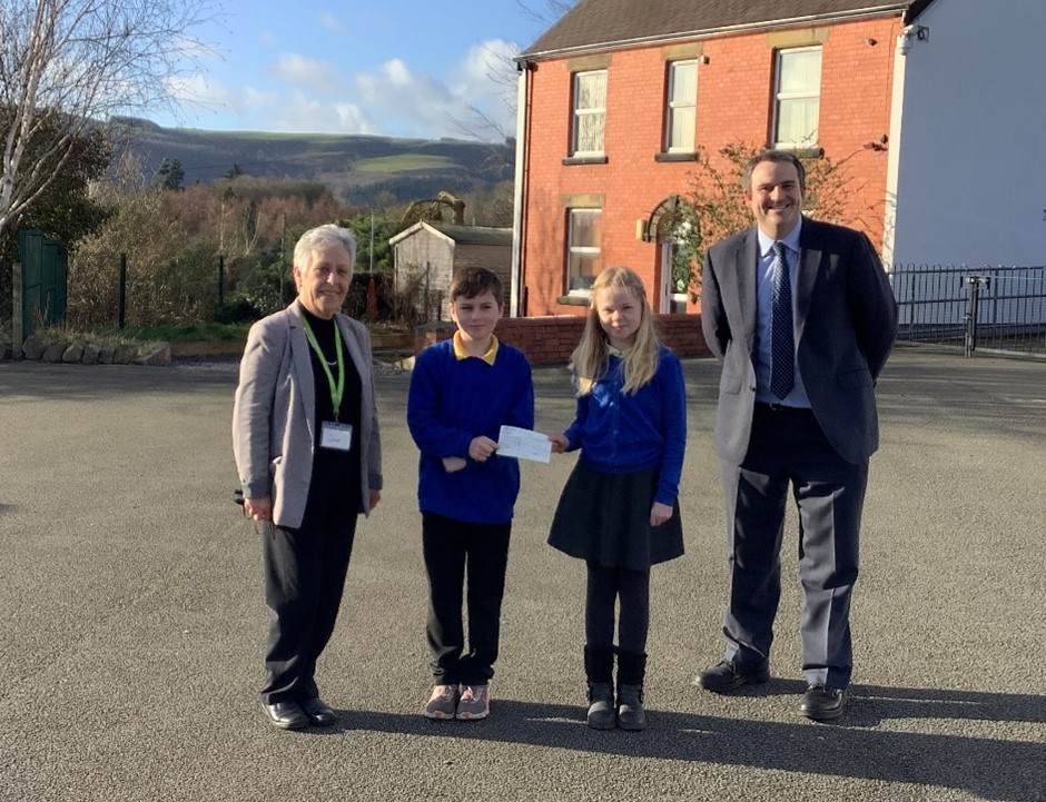 Headteacher Nathan Williams and representatives of the class handing over the donation to Julie Burke, from Barnardo’s.