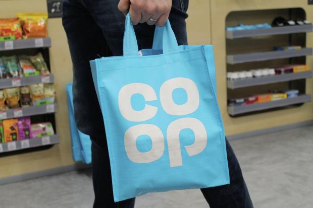 A person carrying a Co-Op bag. Credit: PA