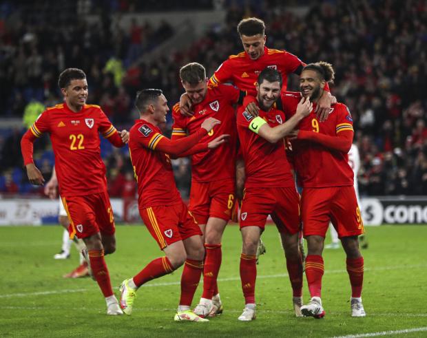 The Leader: Wales' Ben Davies (second right) celebrates scoring their side's fourth goal of the game during the FIFA World Cup Qualifying match at the Cardiff City Stadium, Cardiff. Picture date: Saturday November 13, 2021.
