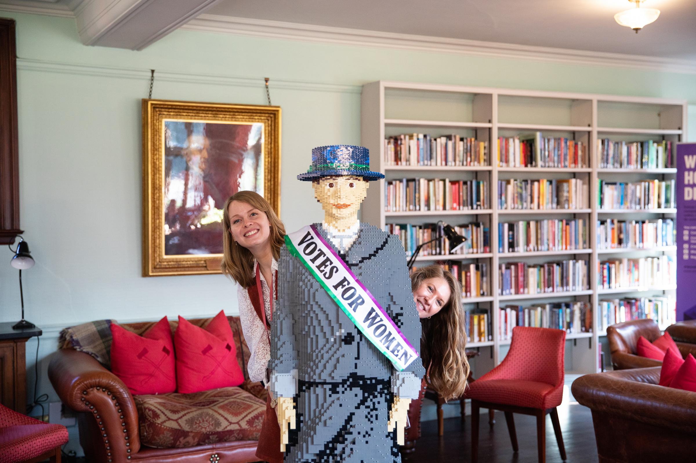 Assistant librarian Isobel Goodman and archivist Alexandra Foulds at Gladstones Library with the LEGO suffragette Hope.