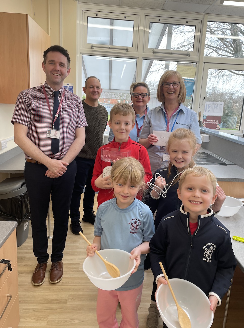 Headteacher Richard Hatwood with Martin Dobie, Lynn Roberts, Karen Jarvis from TC Transcontinental, and pupils from Year 1/2 at All Saints School, Gresford.
