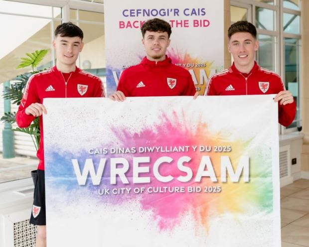 The Leader: Dylan Levitt, Neco Williams and Harry Wilson - all from North Wales - with the Wrecsam 2025 flag.