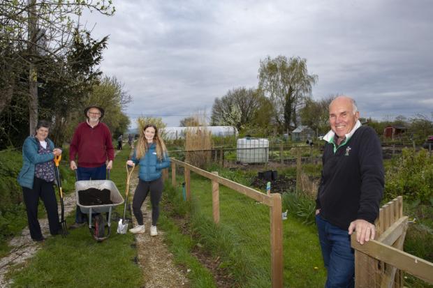The Leader: Haf Roberts, left, and Cara Roberts, of Cadwyn Clwyd, with Holt community gardeners Peter Bostock, left, and Bob Campbell.