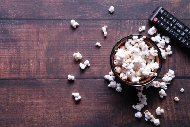 The Leader: A bowl of popcorn and a TV remote (Canva)