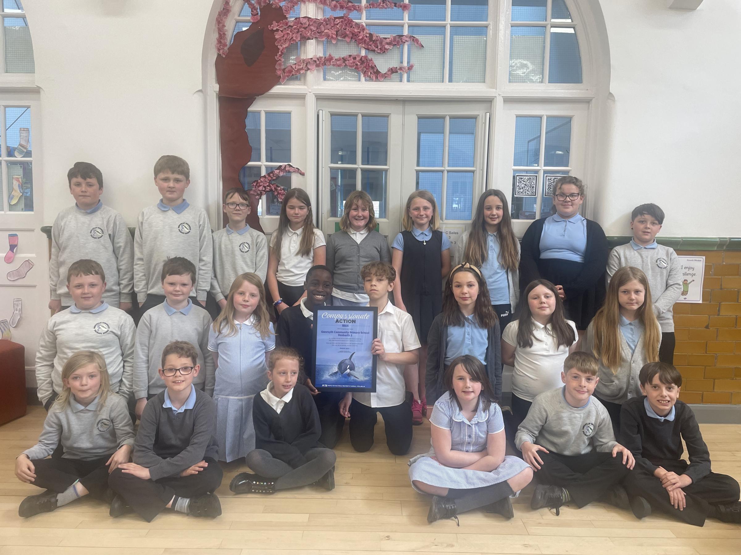 Pupils at Gwersyllt CP School with their Compassionate Action Award from PETA.